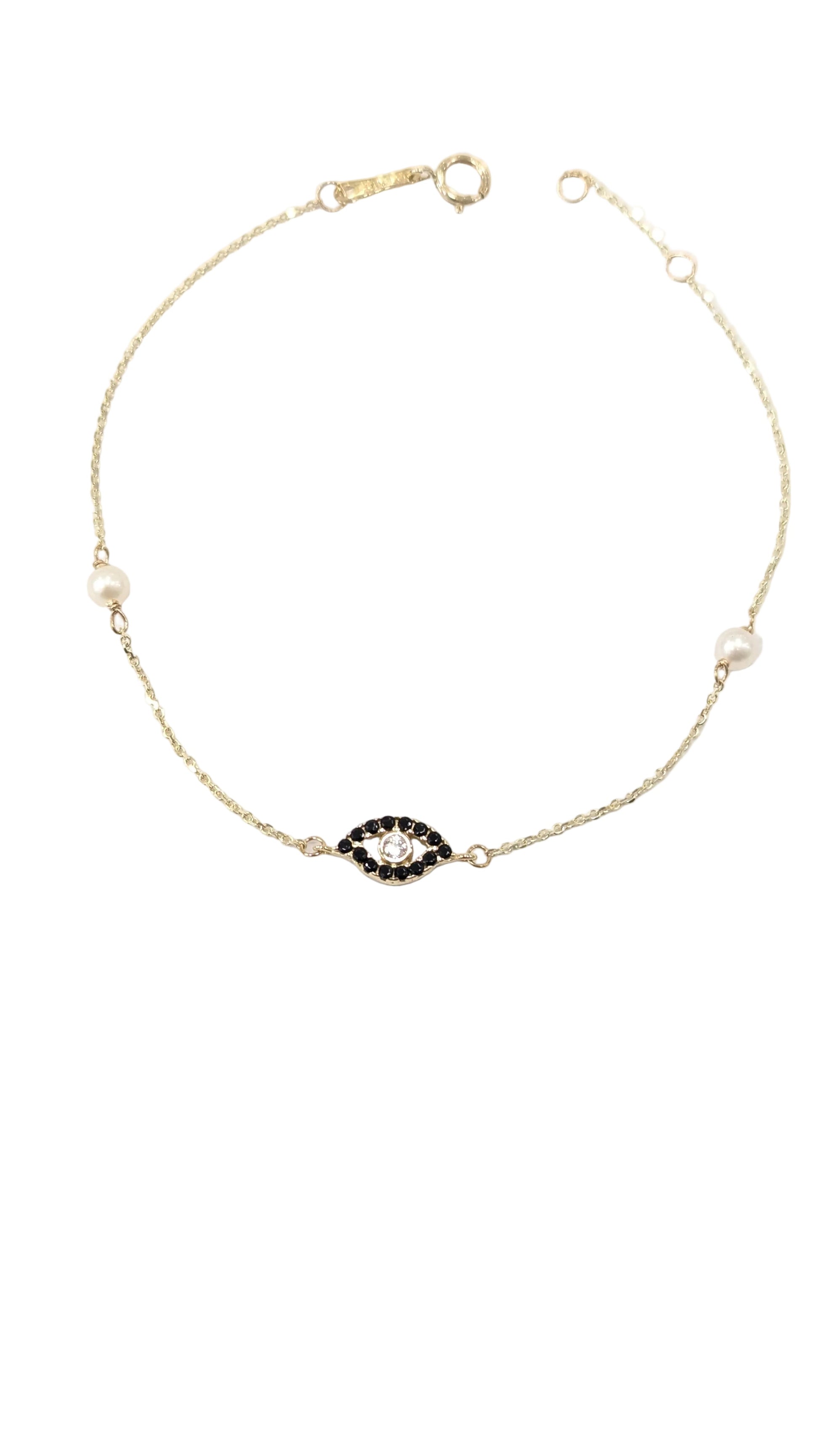 Gold necklace with a black and white gemstone on a white background