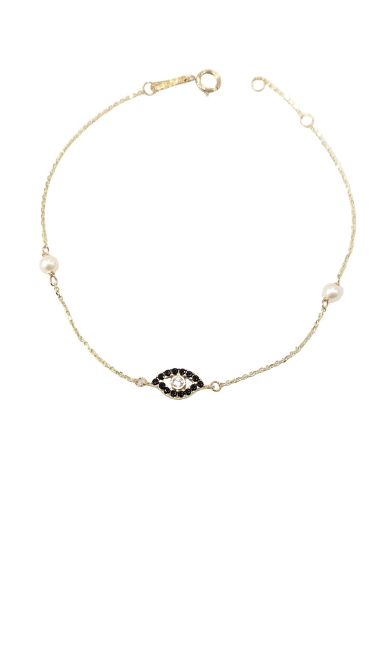 Gold necklace with a black and white gemstone on a white background